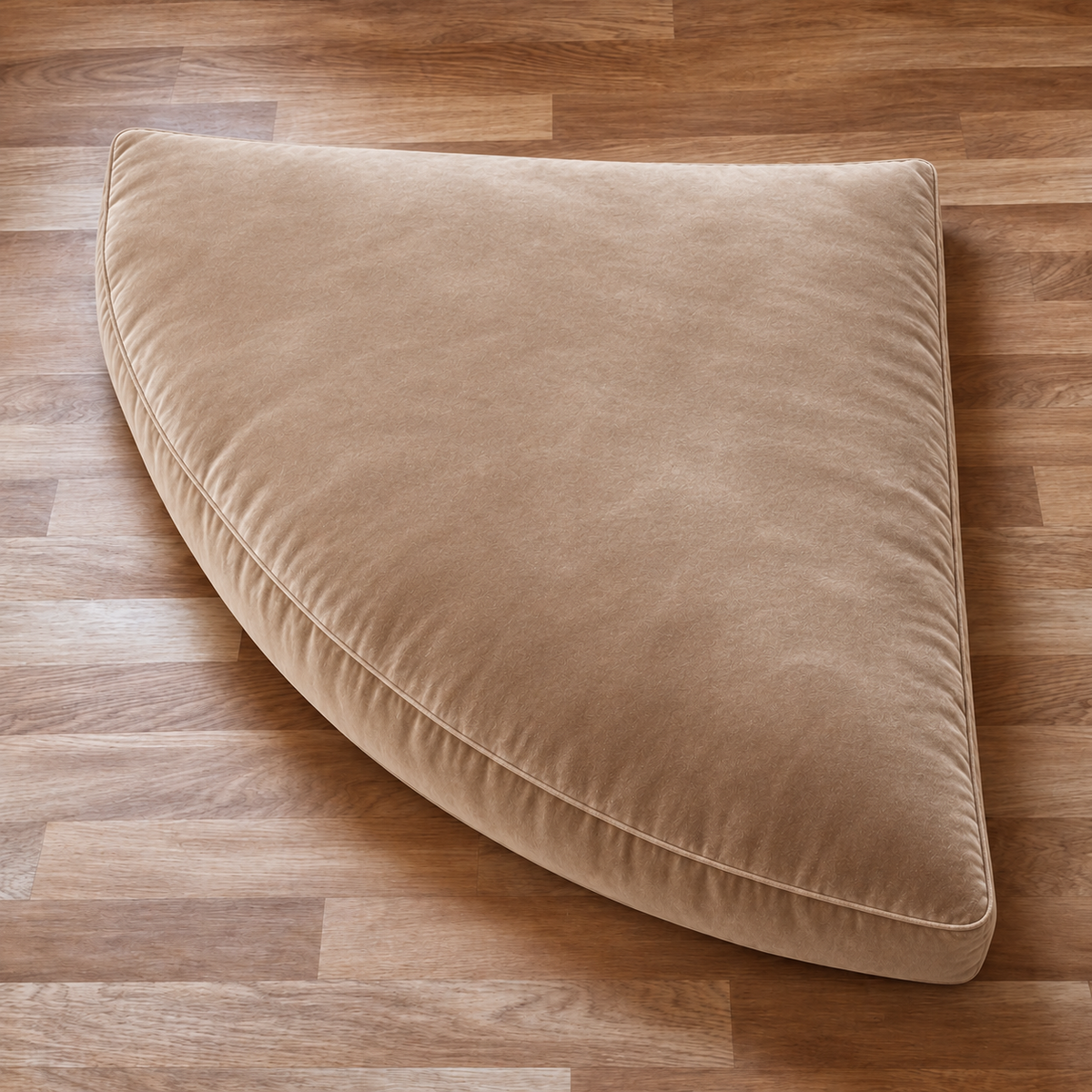 Beige velvet corner floor seater with smooth puffy top and rounded front