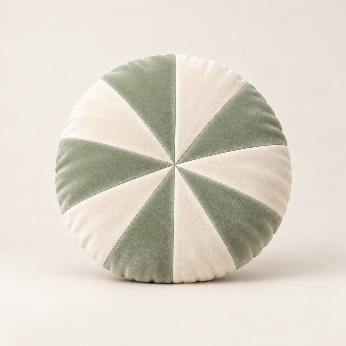 15-inch round pinwheel cushion with alternating sage green and ivory velvet panels