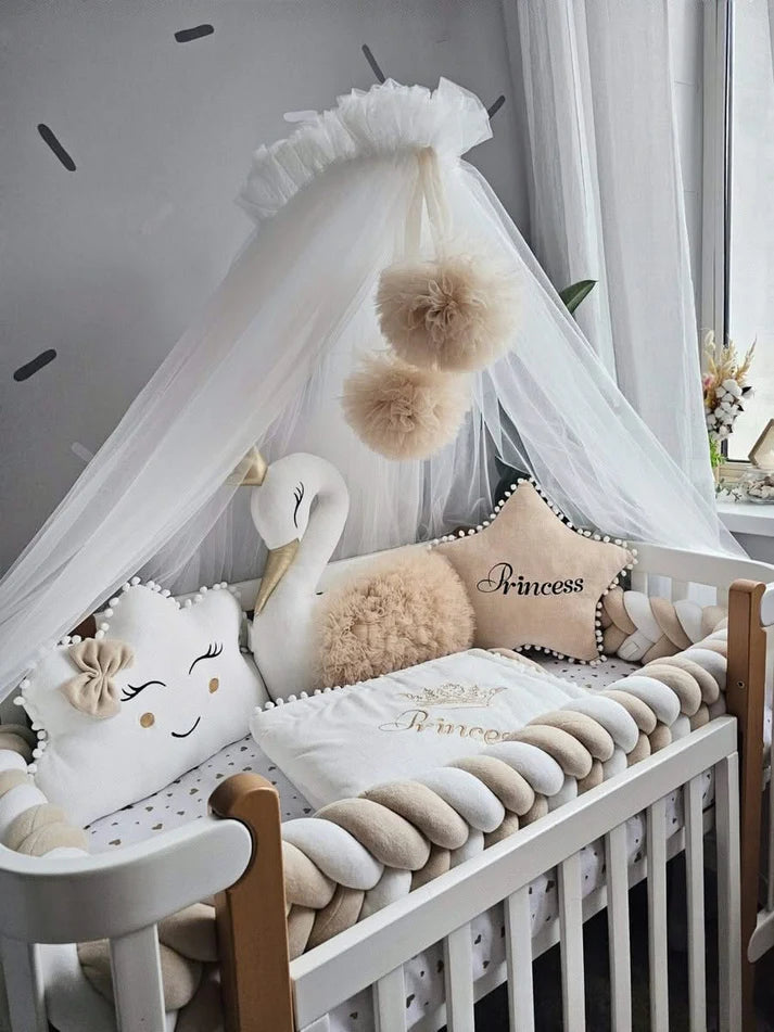 Beige baby crib bedding with braided crib bumper