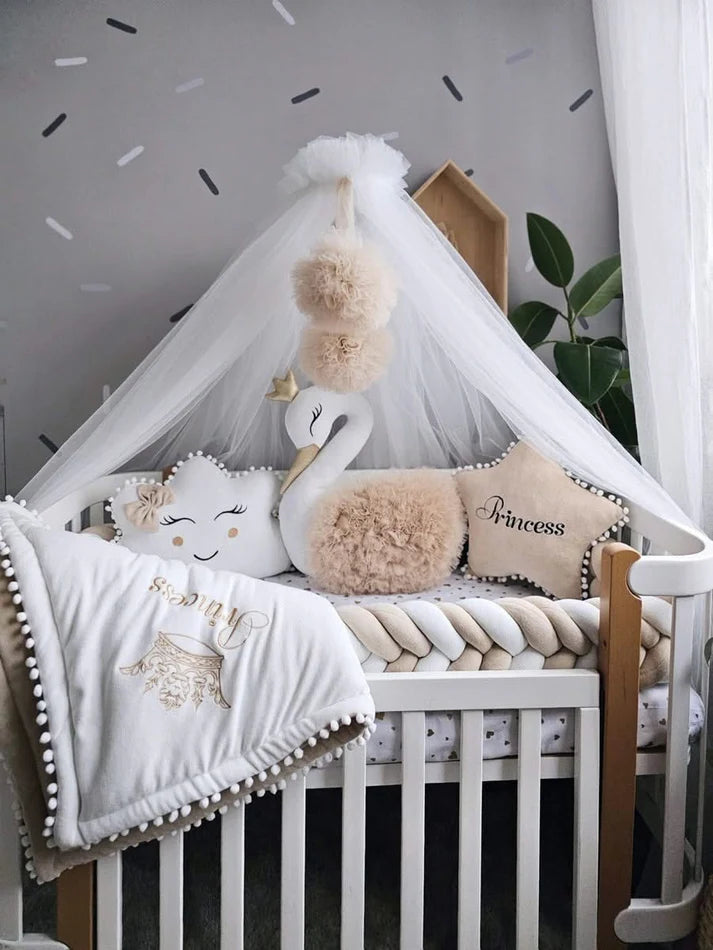 Beige baby crib bedding with braided crib bumper