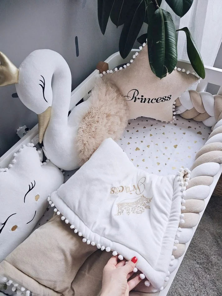 Beige baby crib bedding with braided crib bumper