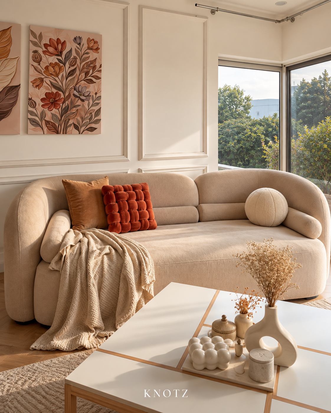 Rust and caramel KNOTZ three-piece sofa cushion set: one 15-inch rust Square Knot, one caramel plain velvet cushion and one ivory ball cushion; digitally styled room image